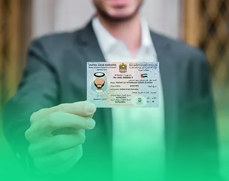 Close-up of a businessman holding an Emirates ID card.