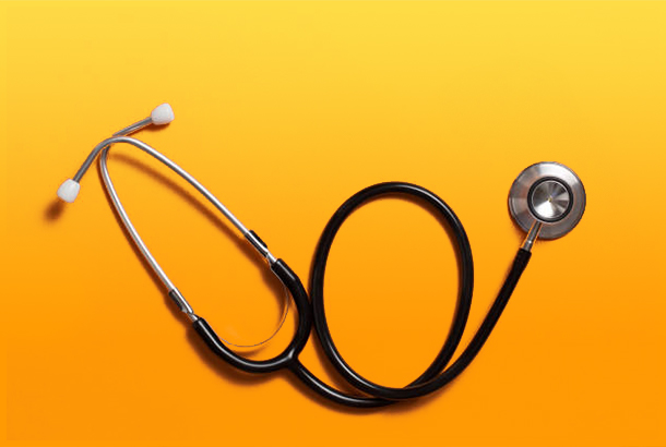 Stethoscope isolated on orange background.