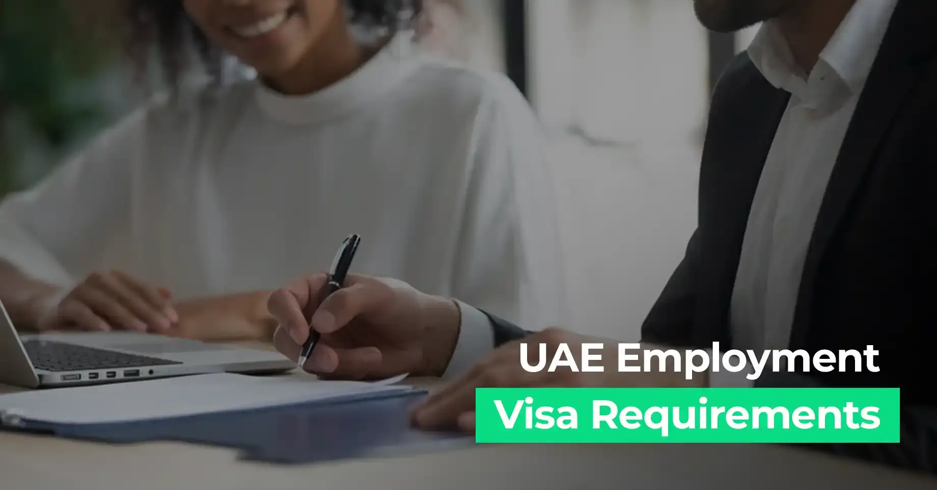 Professionals reviewing UAE employment visa requirements, a focused work meeting image